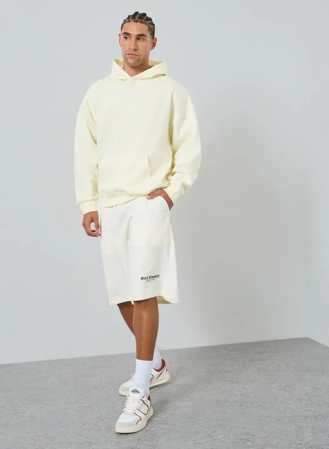 Styli Men Off White Slogan Oversized Shorts